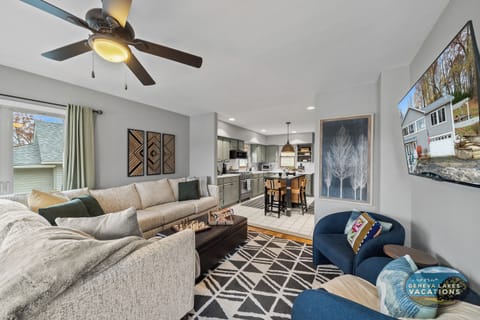 Living room with smart TV (stream your own providers) and open to kitchen