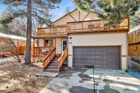 Welcoming cabin entry surrounded by towering pine trees, offering fresh mountain air and a peaceful forest setting—the perfect first impression for your Big Bear Lake getaway.