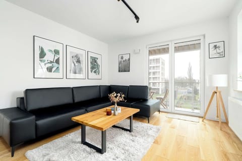Relax in the stylish living room with a comfortable sofa and modern decor.