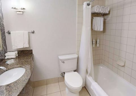 Clean bathroom with tub, shower curtain, and fresh towels
