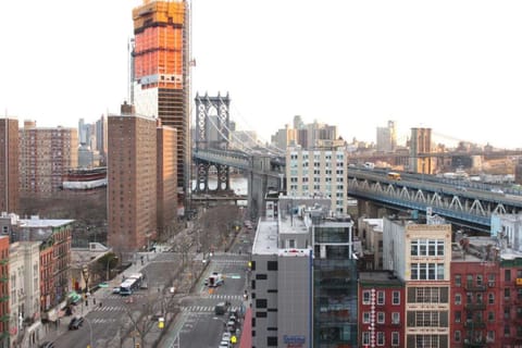 City towers and historic arch glowing at dusk with streets full of motion.