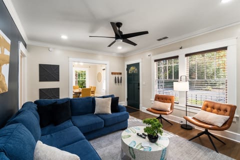 Beautiful bright Living Room with Comfy Sectional Sleeper Sofa, Swivel Chairs, 65" Smart TV.