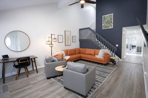 Spacious Living Room with Vaulted Ceilings, 65" Smart TV, Leather Sofa with 2 Leather Swivel Chairs, Workdesk/Chair.