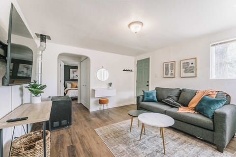 Our bright living area offers an open, uncluttered layout perfect for relaxation. It features a 55-inch Smart TV and a comfortable sofa that converts into a queen sleeper for extra guests.