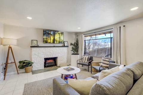 Welcome to Ivywild Flat!  Settle into a warm and inviting living space designed for easy relaxation, featuring a cozy fireplace, plush seating, and natural light that gives the room an open, comfortable feel..