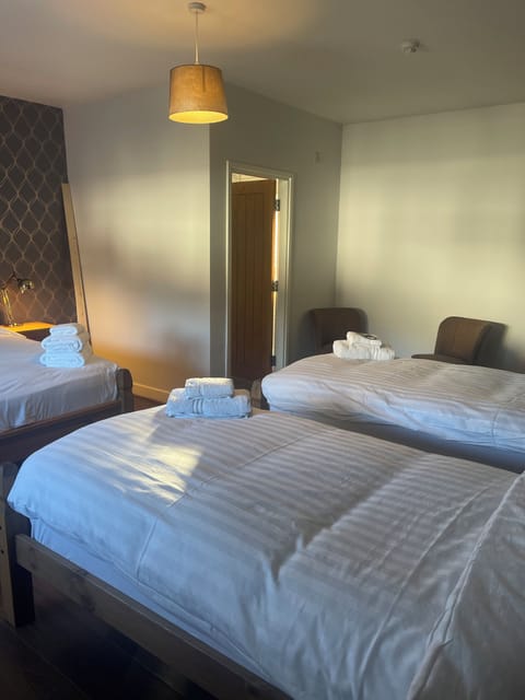 Deluxe Quadruple Room, Courtyard View | Desk, blackout drapes, iron/ironing board, free WiFi