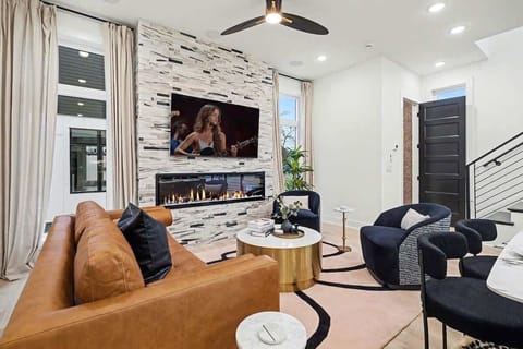 2nd Floor: Bright and open living area with plush furnishings, smart TV, and a fireplace.