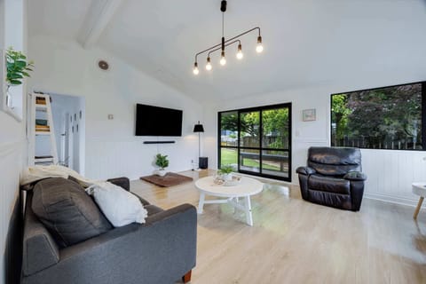 The house has a spacious living area which opens out onto a small deck.