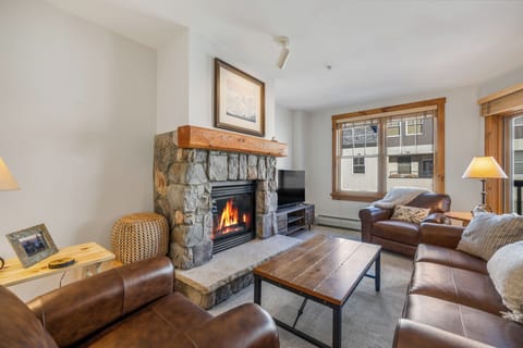 Cozy Living Room with Fireplace and Large Windows to allow Natural Light to flood in