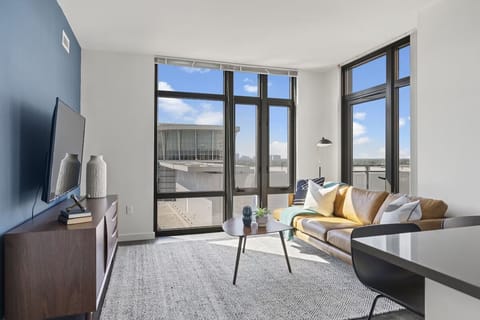 Unwind on the sofa with sunlit skyline views.