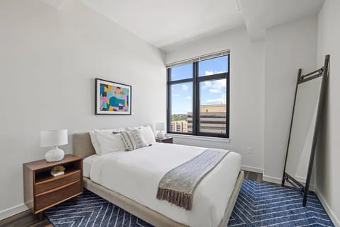 Drift off in crisp linens beside expansive city windows.