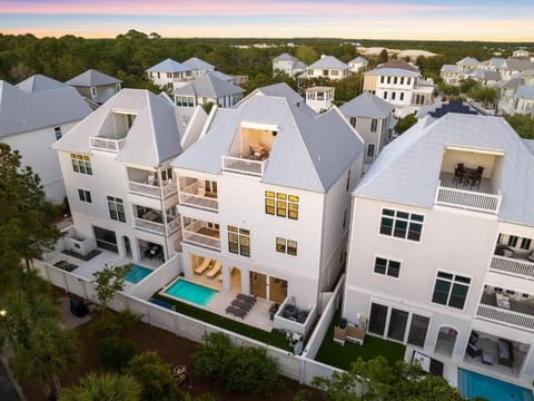 Take in the full backyard from above, showcasing the private pool deck, fenced yard with turf grass, and multiple balconies overlooking the space. Perfect for outdoor fun, relaxing by the pool, or gathering with family and friends!