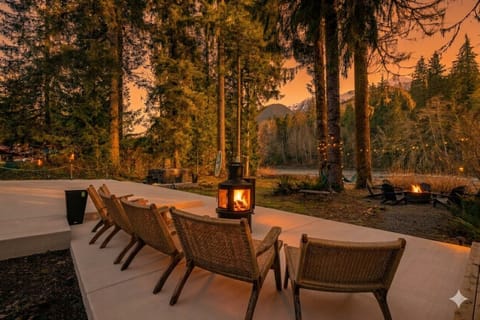 Golden hour, done right. Our new patio is designed for unforgettable evenings. Imagine a crackling fire in the pellet stove, comfortable wicker chairs, and a front-row seat to this incredible river and mountain view.