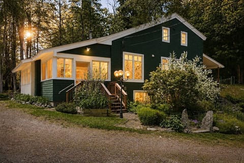 Charming exterior beautifully lit at dusk.