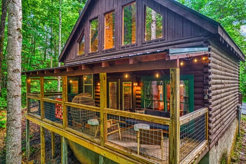 Step onto your back porch oasis! String lights, games, hot tub, and forest views