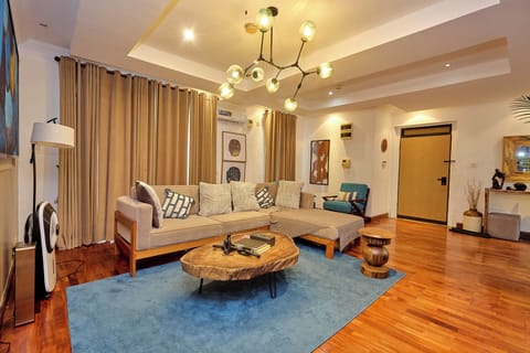 Luxury Apartment, Garden View | Living area | Flat-screen TV