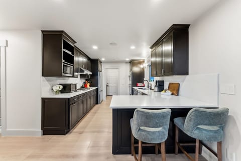 Fully stocked kitchen with everything needed to cook a meal at home.
