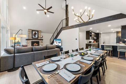 Dining area with seating for 10 guests and 2 additional barstools to the kitchen counter.