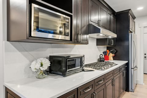 Fully stocked kitchen with everything needed to cook a meal at home.
