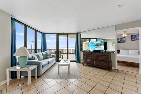 Relax in this bright living room with ocean views and direct balcony access.