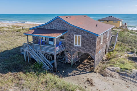 Drone view of parking area, shower under the cottage, front and side entrance