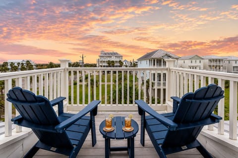 Sunset balcony seating area with Adirondack chairs and spacious deck space, ideal for enjoying colorful Gulf Coast evening skies.
