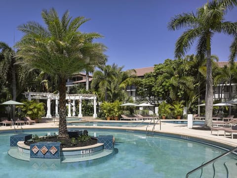 Slip into the refreshing lagoon pool beneath swaying palms.