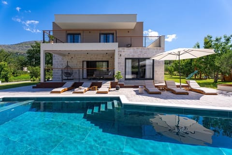 A stylish 4-bedroom retreat with a private pool and spacious balconies for a perfect holiday.