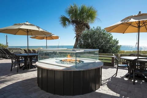 Cozy up by the fire feature with ocean breezes nearby.