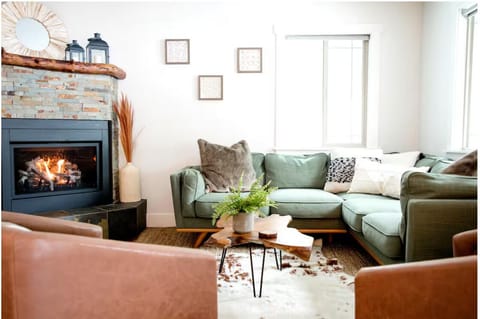 A cozy living room with gas fireplace and smart tv.