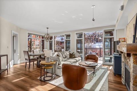 The bright and inviting living room features wall to wall windows that look out to the Fanny Hill lift and Snowmass Base Village