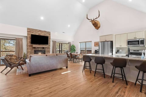 Have a conversation with the cook while sitting at the kitchen counter chairs.