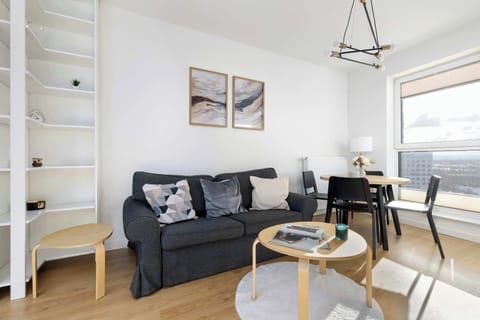 Relax in the stylish living room with a comfortable sofa and modern decor.