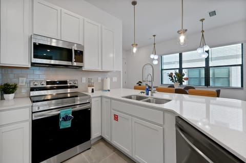 Master your favorite recipes in this stylish kitchen featuring premium appliances and quartz countertops.