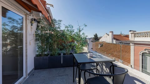 Enjoy privacy and greenery with this charming terrace featuring rooftop views and a serene ambiance. #RooftopRetreat #CityOasis