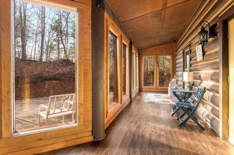 Sun room with floor-to-ceiling windows and forest & mountain views