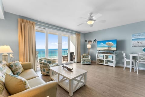 Bright and airy living space featuring panoramic ocean views and cozy beach-themed furnishings for the perfect getaway.