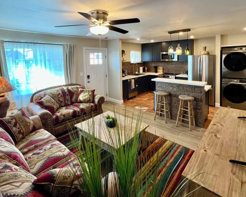 Relax in the spacious, open-concept living room, flowing right into a modern, fully-equipped kitchen. Perfect for gathering!