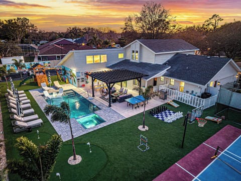 Outdoor Oasis: Dive into luxury with a sparkling pool, vibrant lawn games, and sunset views!