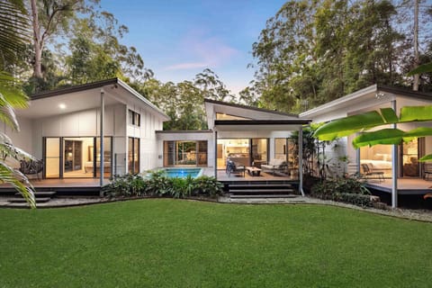 Take in the striking architecture of the main house, with the pool and living spaces opening seamlessly to nature.