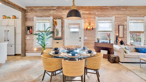 Step into your stylish open-concept retreat with exposed beams, modern dining, and cozy living spaces bathed in natural light.