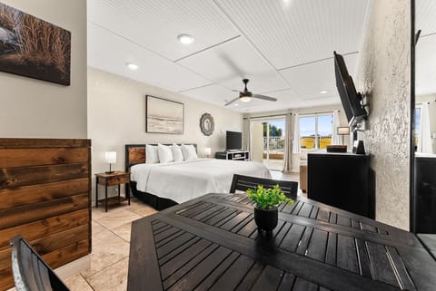Unwind in your stylish bedroom with crisp linens, modern furnishings, and peaceful views through sliding doors to your private balcony.