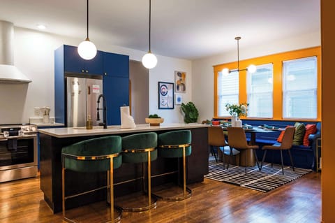 Open-concept kitchen and dining area with modern appliances, stylish seating, and warm natural light—perfect for cooking, gathering, and enjoying meals together