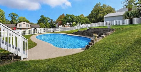 Outdoor pool set in a fenced yard, ideal for sunny days