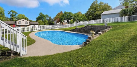 Outdoor pool set in a fenced yard, ideal for sunny days 