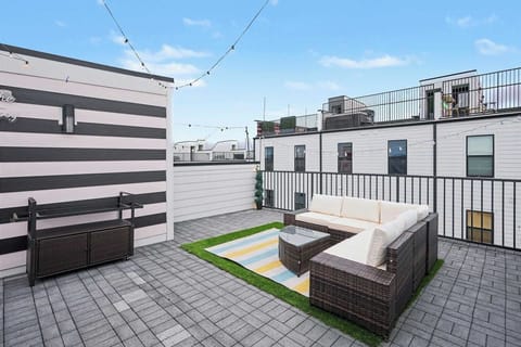 Luxury Rooftop Patio! Giant daybed, sectional seating, faux turf, and perfect string lights.
