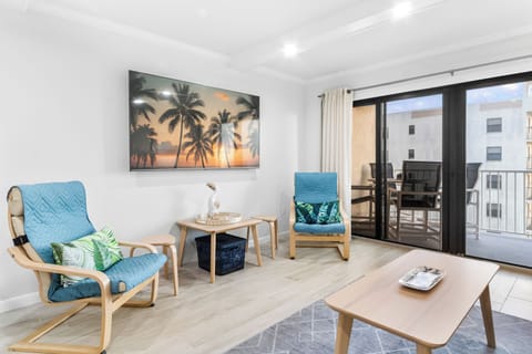 Bright & airy living room with sliding glass doors that lead to outdoor balcony