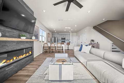 Relax in this open living space with a cozy fireplace and fully equipped modern kitchen.