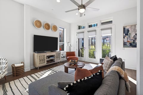 Spacious living room with large windows and modern decor.