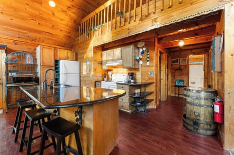 Fully equipped, open-concept kitchen featuring an island with seating and modern appliances